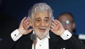FILE - In this Aug. 28, 2019, file photo, Opera star Placido Domingo listens to applause at the end of a concert in Szeged, Hungary. Despite objections from sexual abuse activists, the Israeli Opera will host a week-long singing competition organized by Domingo in Tel Aviv later this year. Domingo has withdrawn from all U.S. performances since reports by The Associated Press last year detailed accusations of sexual harassment or other inappropriate, sexually charged conduct.  (AP Photo/Laszlo Balogh, File)