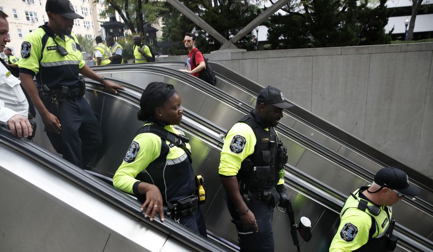 Metro transit police enter the metro at Foggy Bottom on the one year anniversary of the Charlottesville &quot;Unite the Right&quot; rally, Sunday, Aug. 12, 2018, in Washington. (AP Photo/Jacquelyn Martin) **FILE**


