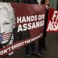 Demonstrators hold banners outside Westminster Magistrates Court in London, Wednesday, Feb. 19, 2020. A case-management hearing regarding Julian Assange will be heard at the court Wednesday. (AP Photo/Kirsty Wigglesworth)