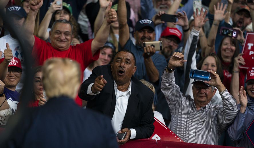 Supporters of President Donald Trump cheer as he arrives to speak at a campaign rally at Veterans Memorial Coliseum, Wednesday, Feb. 19, 2020, in Phoenix. (AP Photo/Evan Vucci)