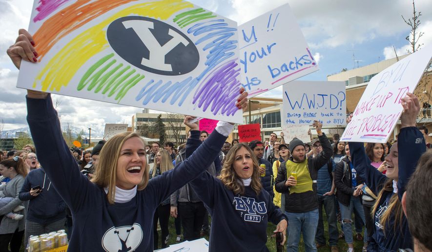 In this April 12, 2019, file photo, Sidney Draughon holds a sign as she takes part in a protest in Provo, Utah, against how the Brigham Young University Honor Code Office investigates and disciplines students. Brigham Young University in Utah has revised its strict code of conduct to strip a rule that banned any behavior that reflected &#x27;homosexual feelings&#x27; which LGBTQ students and their allies felt created an unfair double standard not imposed on heterosexual couples. On June 16, 2021, Education Secretary Miguel Cardona announced his agency will interpret Title IX federal legislation to protect LGBT students from discrimination based on sexual orientation or gender identity, a reversal of policy from the Trump administration and a move which critics fear could endanger religious schools. (Rick Egan/The Salt Lake Tribune via AP, File)