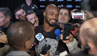 Washington Redskins running back Adrian Peterson smiles as he speaks with the media after a news conference with new head coach Ron Rivera at the team&#39;s NFL football training facility, Thursday, Jan. 2, 2020, in Ashburn, Va. (AP Photo/Alex Brandon)