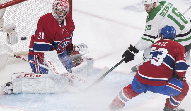 Dallas Stars' Jason Dickinson (18) moves in on Montreal Canadiens goaltender Carey Price as Canadiens' Victor Mete (53) defends during the second period of an NHL hockey game Saturday, Feb. 15, 2020, in Montreal. (Graham Hughes/The Canadian Press via AP)