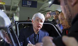 Former Illinois Gov. Rod Blagojevich talks with a well-wisher as he signs a baseball after he arrived at O&#39;Hare International Airport in Chicago after his release from Colorado prison on Tuesday, Feb. 18, 2020. Blagojevich had walked out of prison Tuesday after President Donald Trump cut short the 14-year prison sentence handed to the former Illinois governor for political corruption. (Tim Boyle/Chicago Sun-Times via AP)