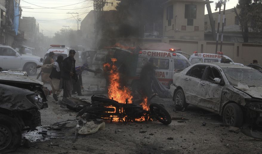 Pakistani rescue workers and volunteers help to remove victims at the site of a suicide bombing in Quetta, Pakistan, Monday, Feb. 17, 2020. The powerful bomb killed a few people and wounded dozen others in Pakistan's restive Baluchistan province local police said, when it struck an Islamist rally in the regional capital. (AP Photo/Arshad Butt)