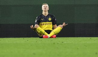 Dortmund&#39;s Erling Braut Haaland poses after scoring his first goal during the Champions League round of 16 first leg soccer match between Borussia Dortmund and Paris Saint Germain in Dortmund, Germany, Tuesday, Feb. 18, 2020. (AP Photo/Martin Meissner)