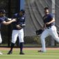 Houston Astros outfielders Josh Reddick and George Springer duck for cover as Michael Brantley runs after a fly ball during spring training baseball practice, Tuesday, Feb. 18, 2020 in West Palm Beach, Fla. (Karen Warren/Houston Chronicle via AP)