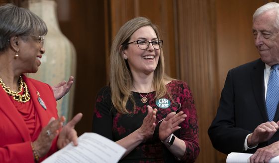 Rep. Jennifer Wexton, D-Va., center, flanked by Rep. Brenda Lawrence, D-Mich., left, and House Majority Leader Steny Hoyer, D-Md., right, applauds in recognition of the recent vote by the Virginia Senate and House of Delegates to ratify the Equal Rights Amendment, during an ERA event at the Capitol in Washington, Wednesday, Feb. 12, 2020. (AP Photo/J. Scott Applewhite) ** FILE **