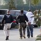 In this March 30, 2012, photo, Immigration and Customs Enforcement (ICE) agents take a suspect into custody as part of a nationwide immigration sweep in Chula Vista, Calif. (AP Photo/Gregory Bull) **FILE**