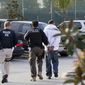 In this March 30, 2012 file photo, Immigration and Customs Enforcement (ICE) agents take a suspect into custody as part of a nationwide immigration sweep in Chula Vista, Calif. San Diego County Sheriff Bill Gore says he will comply with U.S. Immigration and Customs Enforcement's request for information on four people with criminal records, becoming the first state or local law enforcement official in the country to so honor such requests among a spate of jurisdictions whose laws sharply restrict cooperation with immigration authorities. (AP Photo/Gregory Bull,File) **FILE**