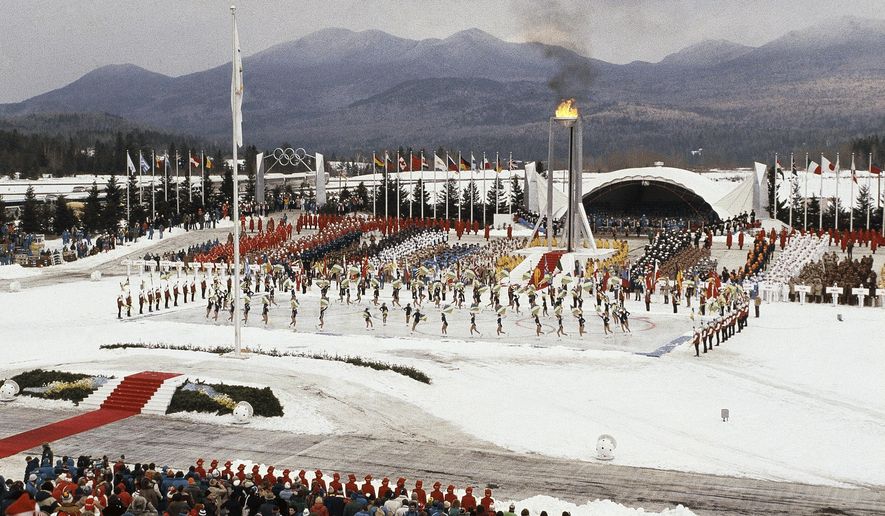 FILE - This Feb. 13, 1980, file photo shows the opening ceremony of the XIII Winter Olympics in Lake Placid, N.Y. Lake Placid is celebrating the 40th anniversary of the Winter Olympics that were held in the Adirondack Mountain village. It&#x27;s an important moment for Lake Placid, which will host the 2023 Winter World University Games, and a reminder of its place as one of only three resort towns to host two Winter Olympiads.(AP Photo)