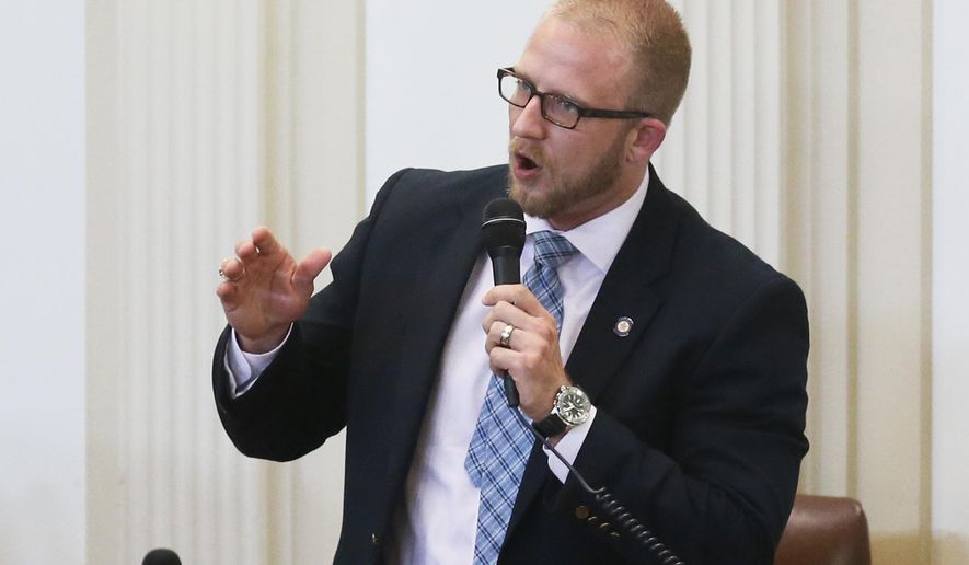 FILE - In this April, 17, 2017, file photo, state Rep. Collin Walke, D-Oklahoma City, speaks on the House floor in Oklahoma City. The Native American Caucus in Oklahoma's House of Representatives, led by Walke and Rep. Ken Luttrell, R-Ponca City, says it plans to push bills in the 2020 legislative session that will help bridge communication gaps between lawmakers on matters that affect tribal issues. (AP Photo/Sue Ogrocki, File)
