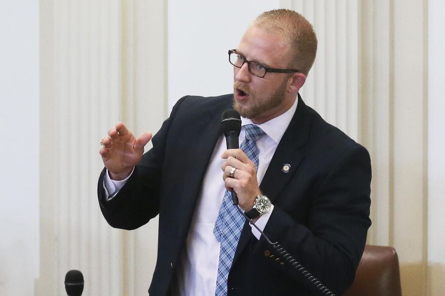 FILE - In this April, 17, 2017, file photo, state Rep. Collin Walke, D-Oklahoma City, speaks on the House floor in Oklahoma City. The Native American Caucus in Oklahoma's House of Representatives, led by Walke and Rep. Ken Luttrell, R-Ponca City, says it plans to push bills in the 2020 legislative session that will help bridge communication gaps between lawmakers on matters that affect tribal issues. (AP Photo/Sue Ogrocki, File)