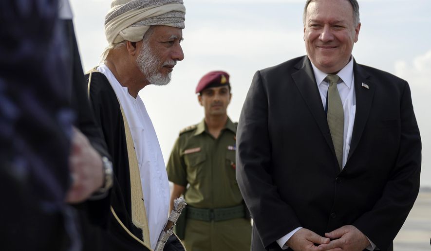 US Secretary of State Mike Pompeo is greeted by Oman&#x27;s Minister of Foreign Affairs Yusuf bin Alawi bin Abdullah, left, upon his arrival in the Oman capital of Muscat, Friday Feb. 21, 2020. (Andrew Caballero-Reynolds/Pool via AP)