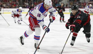 New York Rangers center Ryan Strome (16) tries to take a shot against Carolina Hurricanes defenseman Brett Pesce (22) during the first period of an NHL hockey game in Raleigh, N.C., Friday, Feb. 21, 2020. (AP Photo/Gerry Broome)