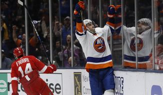 New York Islanders right wing Jordan Eberle reacts toward the crowd after scoring his second goal of the night, during the second period of the team&#39;s NHL hockey gam against the Detroit Red Wings ,as Red Wings center Robby Fabbri (14) skates away, Friday, Feb. 21, 2020, in Uniondale, N.Y. (AP Photo/Kathy Willens)