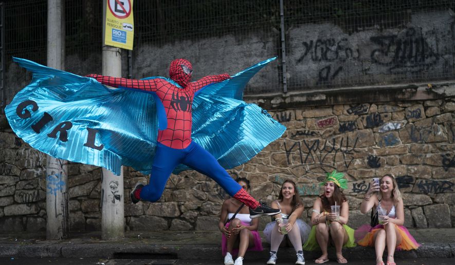 A reveler dressed in Spider-Man costume strikes a pose at the &amp;quot;Ceu na Terra&amp;quot; or Heaven on Earth street party in Rio de Janeiro, Brazil, Saturday, Feb. 22, 2020. From very early in the morning revelers take the streets of the bohemian neighborhood Santa Teresa for one of the many block parties during the Carnival celebrations in the city. (AP Photo/Leo Correa)