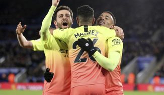 Manchester City&#39;s Gabriel Jesus, right, celebrates scoring his side&#39;s first goal of the game against Leicester with team mates Riyad Mahrez, centre, and Mota Bernardo Silva during their English Premier League soccer match at the King Power Stadium in Leicester, England, Saturday Feb. 22, 2020. (Nick Potts/PA via AP)
