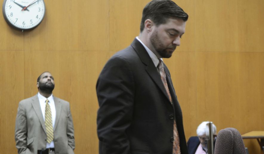 Assistant District Attorney Brendon Adams talks to the court reporter, unseen, during a break in testimony Friday, Feb. 21, 2020 while defendant Willie Cory Godbolt, left, waits for his attorneys on Day 7 of Godbolt's capital murder trial in the Pike County Courthouse in Magnolia, Miss. Godbolt, 37, is on trial, for the May 2017 shooting deaths of eight people in Brookhaven. (Donna Campbell/The Daily Leader via AP, Pool)