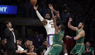 Los Angeles Lakers&#39; LeBron James (23) is defended by Boston Celtics&#39; Marcus Smart (36) and Jayson Tatum during the first half of an NBA basketball game Sunday, Feb. 23, 2020, in Los Angeles. (AP Photo/Marcio Jose Sanchez)