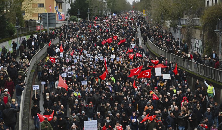 Thousands of people take part in a funeral march in Hanau, Germany, Sunday, Feb. 23, 2020. Several people were killed in a shooting in the central German city late Wednesday, Feb. 19, 2020. (Nicolas Armer/dpa via AP)
