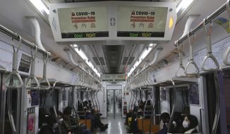 Electric screens about precautions against the illness COVID-19 are seen in a subway train in Seoul, South Korea, Sunday, Feb. 23, 2020. South Korea&#39;s president said Sunday that he was putting his country on its highest alert for infectious diseases and ordered officials to take &amp;quot;unprecedented, powerful&amp;quot; steps to fight a soaring viral outbreak. (AP Photo/Ahn Young-joon)