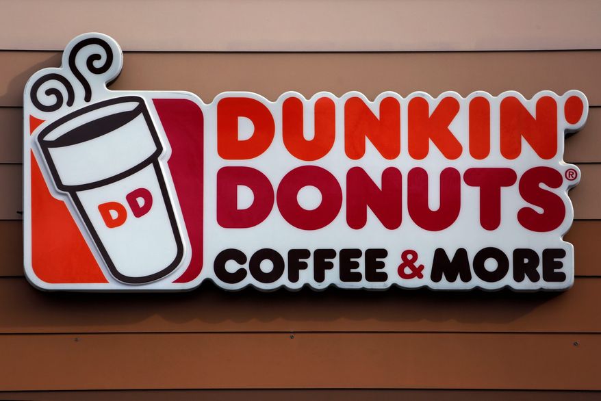 FILE- This Jan. 22, 2018 file photo shows the Dunkin' Donuts logo on a shop in Mount Lebanon, Pa. The Dunkin coffee chain says customers will have to do without a double cup for their iced drinks.A new campaign focused in Massachusetts and Rhode Island tells customers they can no longer nest their iced drinks in a second, foam cup for extra insulation as the company moves to eliminate its polystyrene cups. (AP Photo/Gene J. Puskar, File)