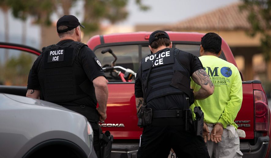 U.S. Immigration and Custom Enforcement officer makes an arrest. (Associated Press file photo)