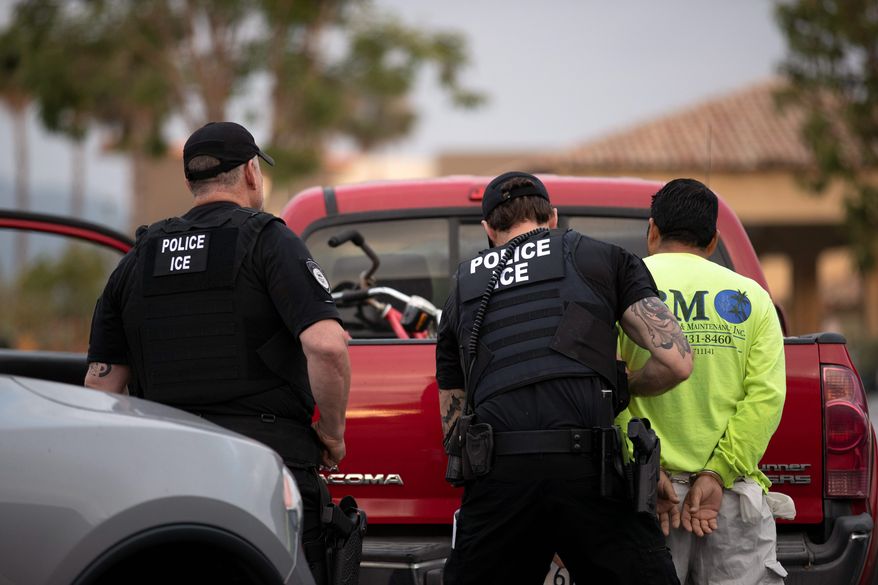 U.S. Immigration and Custom Enforcement officer makes an arrest. (Associated Press file photo)