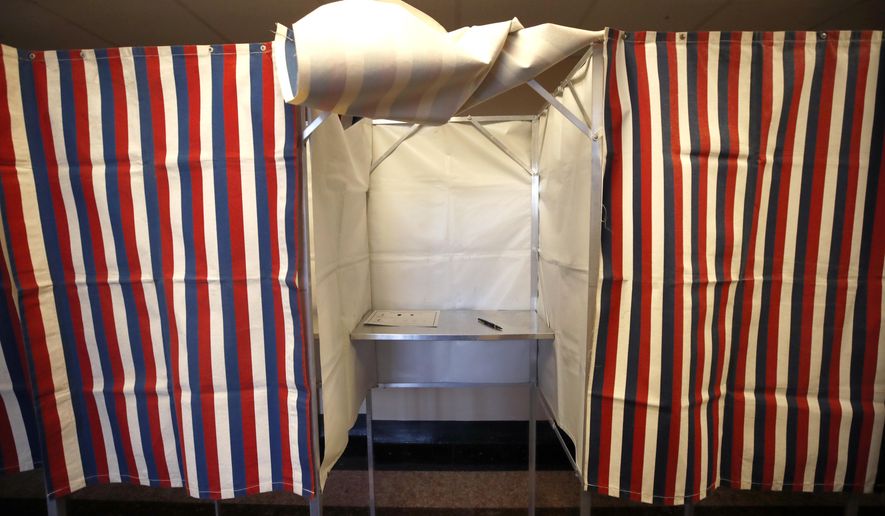 A booth is ready for a voter, Monday, Feb. 24, 2020, at City Hall in Cambridge, Mass. on the first morning of early voting in the state. (AP Photo/Elise Amendola)