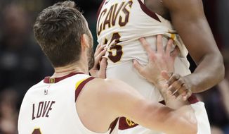 Cleveland Cavaliers&#39; Tristan Thompson (13) and Kevin Love (0) celebrate after they defeated the Miami Heat in overtime in an NBA basketball game, Monday, Feb. 24, 2020, in Cleveland. (AP Photo/Tony Dejak)