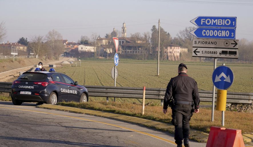 Carabinieri (Italian paramilitary police) officers set a road block in Codogno, Northern Italy, Monday, Feb. 24, 2020. Italy scrambled to check the spread of Europe&#x27;s first major outbreak of the new viral disease amid rapidly rising numbers of infections and a third death. Road blocks were set up in at least some of 10 towns in Lombardy at the epicenter of the outbreak, to keep people from leaving or arriving. (AP Photo/Paolo Santalucia)