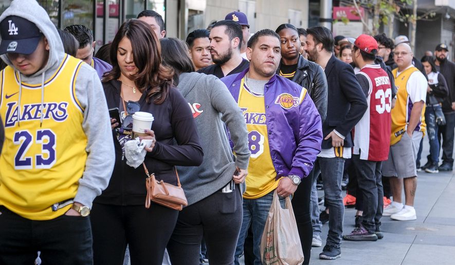 Fans line up to get into the Staples Center to attend a public memorial for former Los Angeles Lakers star Kobe Bryant and his daughter, Gianna, in Los Angeles, Monday, Feb. 24, 2020.  (AP Photo/Ringo H.W. Chiu)