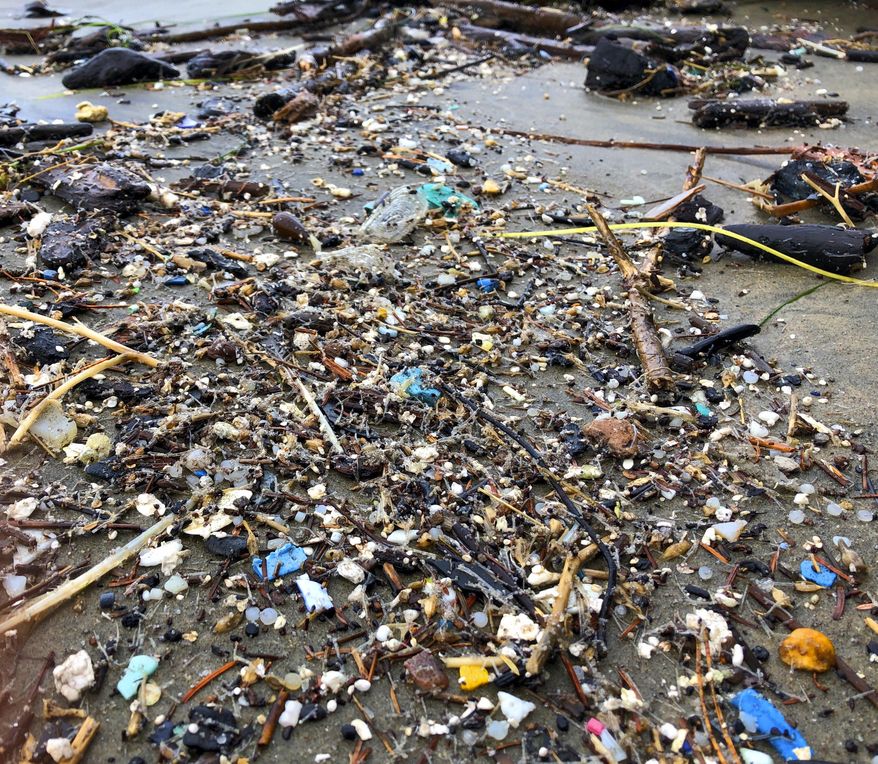 This Jan. 19, 2020, photo shows microplastic debris that has washed up at Depoe Bay, Ore. Dozens of scientists from around the U.S. West will attend a gathering this week in Bremerton, Wash., to better focus the research on the environmental threat. (AP Photo/Andrew Selsky) **FILE**