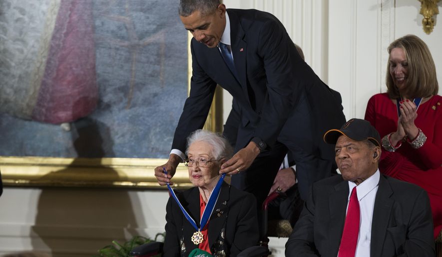 In this Nov. 24, 2015, file photo, Willie Mays, right, looks on as President Barack Obama presents the Presidential Medal of Freedom to NASA mathematician Katherine Johnson during a ceremony in the East Room of the White House, in Washington. Johnson, a mathematician on early space missions who was portrayed in film &amp;quot;Hidden Figures,&amp;quot; about pioneering black female aerospace workers, died Monday, Feb. 24, 2020. (AP Photo/Evan Vucci, File)