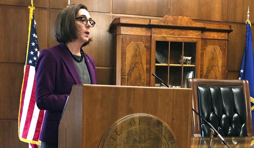 Gov. Kate Brown of Oregon denounces a walkout by Republicans in the state Senate that prevented a quorum on Monday, Feb. 24, 2020 in Salem, Ore. Republican lawmakers are trying to doom a contentious climate change bill. Brown said the Republicans are not against the climate policy but are against the Democratic process. (AP Photo/Andrew Selsky)