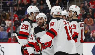 New Jersey Devils right wing Kyle Palmieri (21) celebrates his goal with Damon Severson (28), Travis Zajac (19), and Nico Hischier (13) in the second period of an NHL hockey game against the Detroit Red Wings, Tuesday, Feb. 25, 2020, in Detroit. (AP Photo/Paul Sancya)
