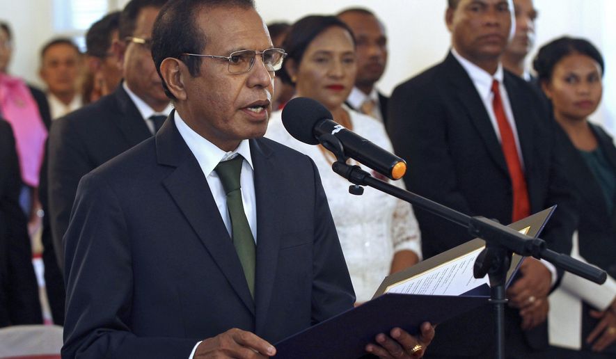 FILE - In this June 22, 2018, file photo, East Timorese Prime Minister Taur Matan Ruak reads out the oath of office during his inauguration in Dili, the capital of East Timor. The prime minister offered his resignation Tuesday, Feb. 25, 2020, after the budget failed to pass in Parliament. (AP Photo/Kandhi Barnez, File)