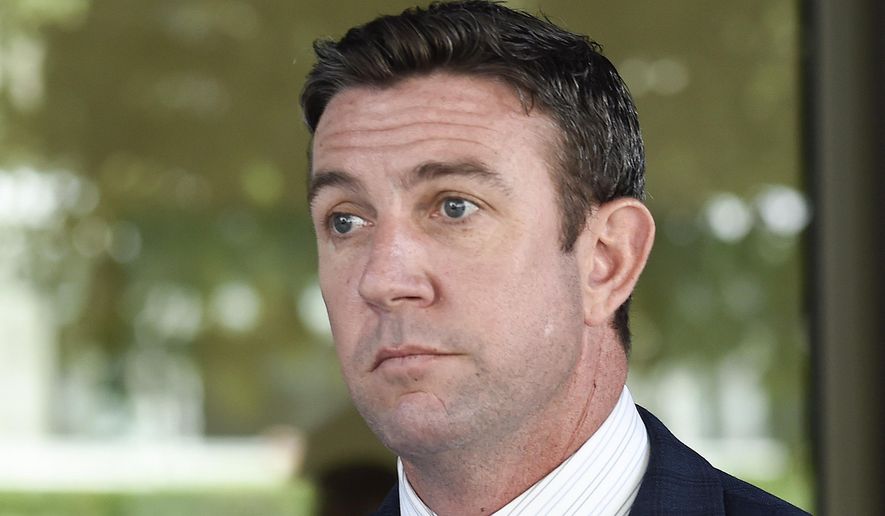 In this July 1, 2019, file photo, U.S. Rep. Duncan Hunter leaves federal court after a motions hearing in San Diego. The race to fill the vacated seat of Hunter, of California, has turned into a GOP slugfest. Hunter held one of the party&#39;s few remaining House seats in California before he pleaded guilty to a corruption charge and resigned last month. The race to replace him has been especially bitter between the Republican front-runners, former congressman Darrell Issa and San Diego radio host and political commentator Carl DeMaio. (AP Photo/Denis Poroy, File)