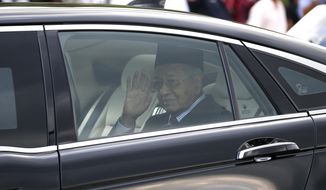 Malaysia&#39;s Prime Minister Mahathir Mohamad waves after granted an audience with the Malaysia&#39;s King Sultan Abdullah Sultan Ahmad Shah at the National Palace in Kuala Lumpur, on Monday, Feb. 24, 2020. Mahathir has resigned as the Malaysia&#39;s 7th Prime Minister on Feb. 24, 2020. (AP Photo/FL Wong)