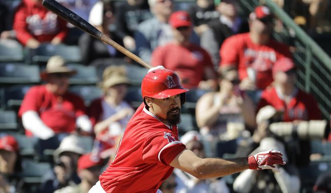 Los Angeles Angels&#x27; Anthony Rendon hits an RBI single during the second inning of a spring training baseball game against the Cincinnati Reds, Tuesday, Feb. 25, 2020, in Tempe, Ariz. (AP Photo/Darron Cummings)