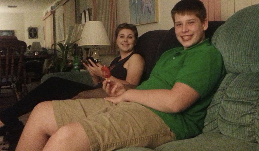 In this July 2016 photo made available by Laurie Giordano, her son Zachary and her daughter Vanessa sit together an an undisclosed location. Zach, a rising junior at a high school in Florida, collapsed while at a football practice in the summer of 2017. He died 11 days later. On Wednesday, April 26, 2020, a Florida legislative committee honored the teenager by renaming a proposed law after him that would put safety measures in place to protect student athletes from deadly heat strokes. (Laurie Giordano via AP)
