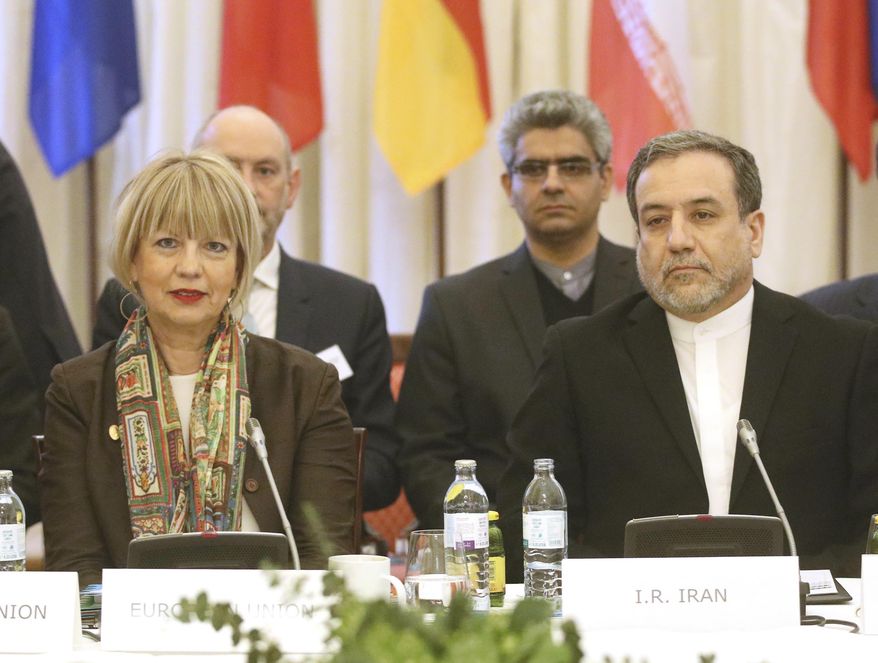 The European Union's political director Helga Schmid and Iran's deputy Foreign Minister Abbas Araghchi, from left, wait for a bilateral meeting as part of the closed-door nuclear talks with Iran in Vienna, Austria, Wednesday, Feb. 26, 2020. (AP Photo/Roland Zak)