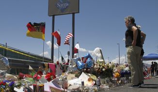 In this Aug. 12, 2019 photo, mourners visit the makeshift memorial near the Walmart in El Paso, Texas, where 22 people were killed in a mass shooting that police are investigating as a terrorist attack targeting Latinos. White supremacists and other far-right extremists killed at least 38 people in the U.S. in 2019, the sixth deadliest year for violence by all domestic extremists since 1970, according to a report issued, Thursday, Feb. 27, 2020, by a group that fights anti-semitism. (AP Photo/Cedar Attanasio, File)