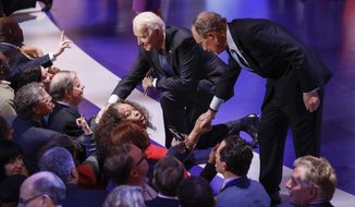 Democratic presidential candidates, former New York City Mayor Mike Bloomberg, right, and former Vice President Joe Biden, left, greet supporters at the end of the Democratic presidential primary debate at the Gaillard Center, Tuesday, Feb. 25, 2020, in Charleston, S.C., co-hosted by CBS News and the Congressional Black Caucus Institute. (AP Photo/Patrick Semansky)