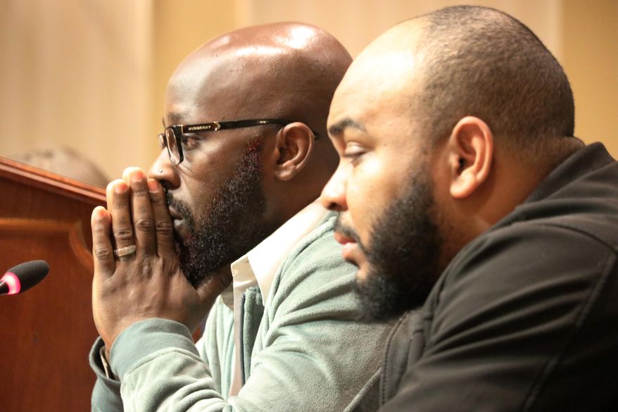 Eric Simmons (left) and Demetrius Smith, who were found innocent after spending years in prison for crimes they did not commit in Maryland, testify before state lawmakers for legislation to address how the wrongly incarcerated should be compensated by the state during a hearing Wednesday, Feb. 26, 2020 in Annapolis, Md. (AP Photo/Brian Witte)