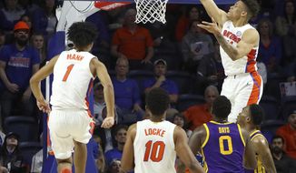 Florida guard Keyontae Johnson (11) catches the ball above the rim and slams it down after a pass from teammate Tre Mann (1) during an NCAA college basketball game against LSU, Wednesday, Feb. 26, 2020 in Gainesville, Fla.  (Brad McClenny/The Gainesville Sun via AP)