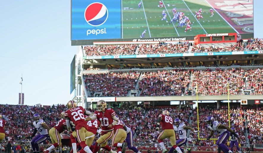 FILE - In this Jan. 11, 2020, file photo, San Francisco 49ers quarterback Jimmy Garoppolo (10) hands off to running back Tevin Coleman (26) during the first half of an NFL divisional playoff football game against the Minnesota Vikings at Levi's Stadium in Santa Clara, Calif. The current collective bargaining agreement expires in March 2021, but NFL owners are eager to get a new contract in place as soon as possible. That would enable them to begin looking toward new, lucrative broadcast deals, with a decade of labor peace assured. But the players don't appear to be in a rush to approve the new agreement that is the result of 10 months of negotiations between the sides. Indeed, several player reps last Friday night were adamant that more negotiating is needed. (AP Photo/Tony Avelar, File)