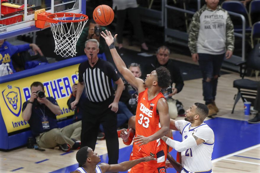 Syracuse&#x27;s Elijah Hughes (33) scores after getting by Pittsburgh&#x27;s Terrell Brown (21) during the second half of an NCAA college basketball game, Wednesday, Feb. 26, 2020, in Pittsburgh. (AP Photo/Keith Srakocic)