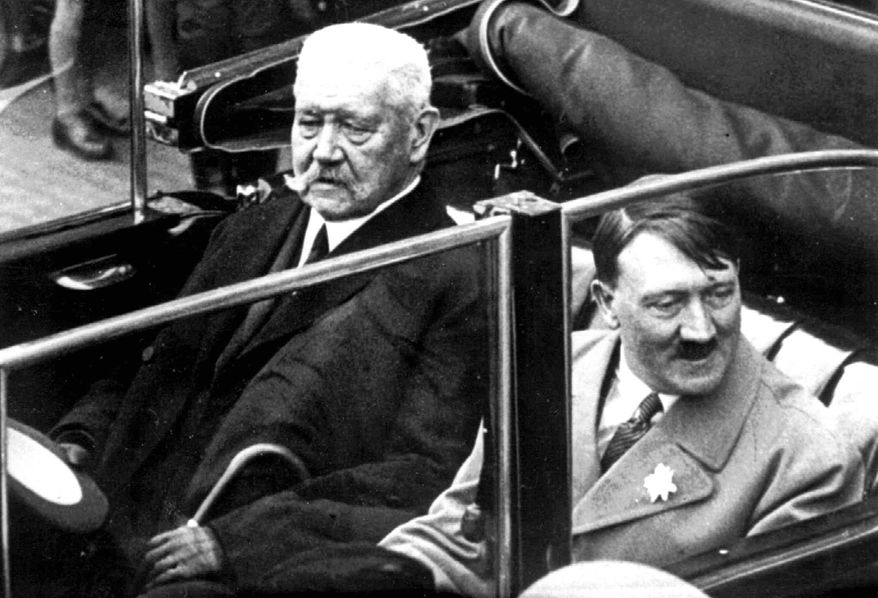 In this May 1, 1933 file photo German President Paul von Hindenburg, left, and Adolf Hitler, right, sit in a car during a labor day celebration in Berlin. The Berlin state government on Thursday struck the Prussian aristocrat Paul von Hindenburg off of its honorary citizen list, citing his act as president in 1933 of appointing Hitler as chancellor, the dpa news agency reported. Hindenburg was elected president in 1925 and served in that role until his death in 1934. (AP Photo)